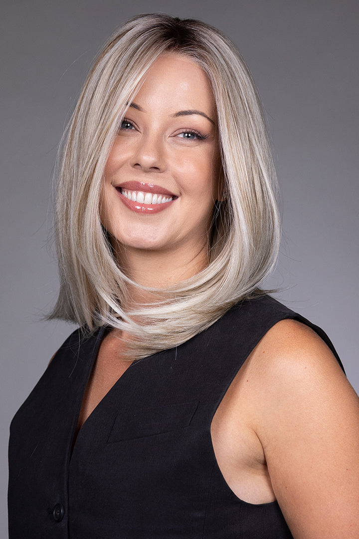 Adriana by Belle Tress layered blonde bob wig with a lace front and monofilament top on a smiling model.