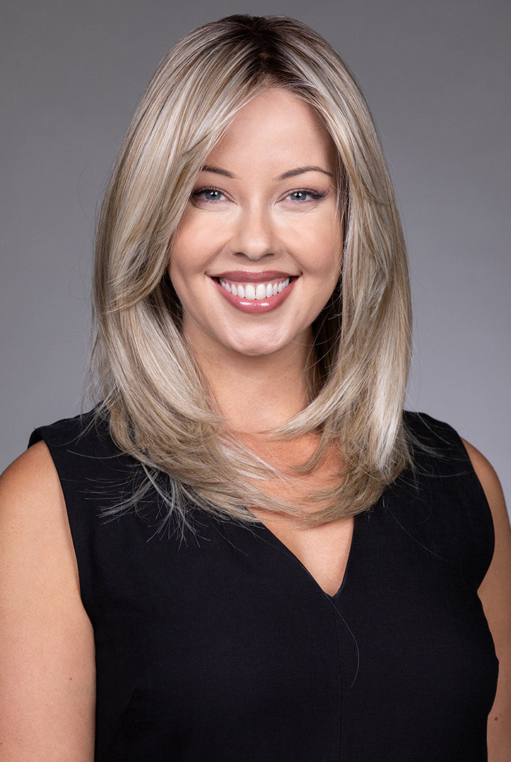 Bailey by Belle Tress mid-length blonde layered synthetic wig with a natural lace front and monofilament top.
