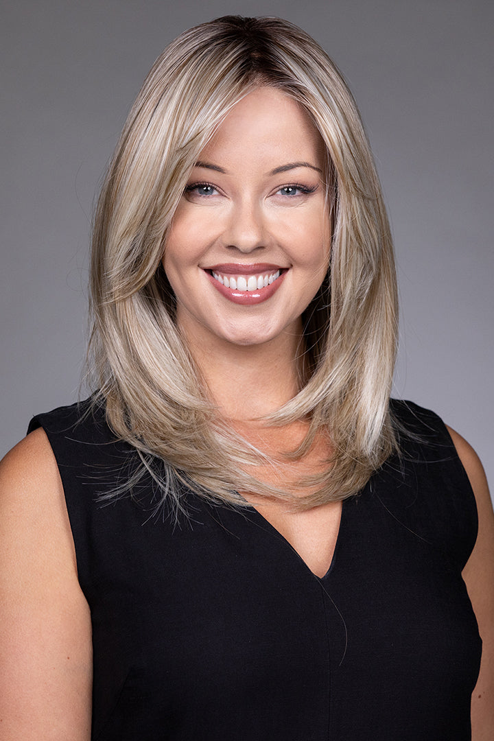 Bailey by Belle Tress mid-length blonde layered synthetic wig with a natural lace front and monofilament top.