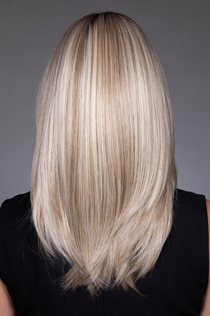 Back view of Bailey by Belle Tress mid-length blonde synthetic wig with sleek, layered, shoulder-grazing hair.
