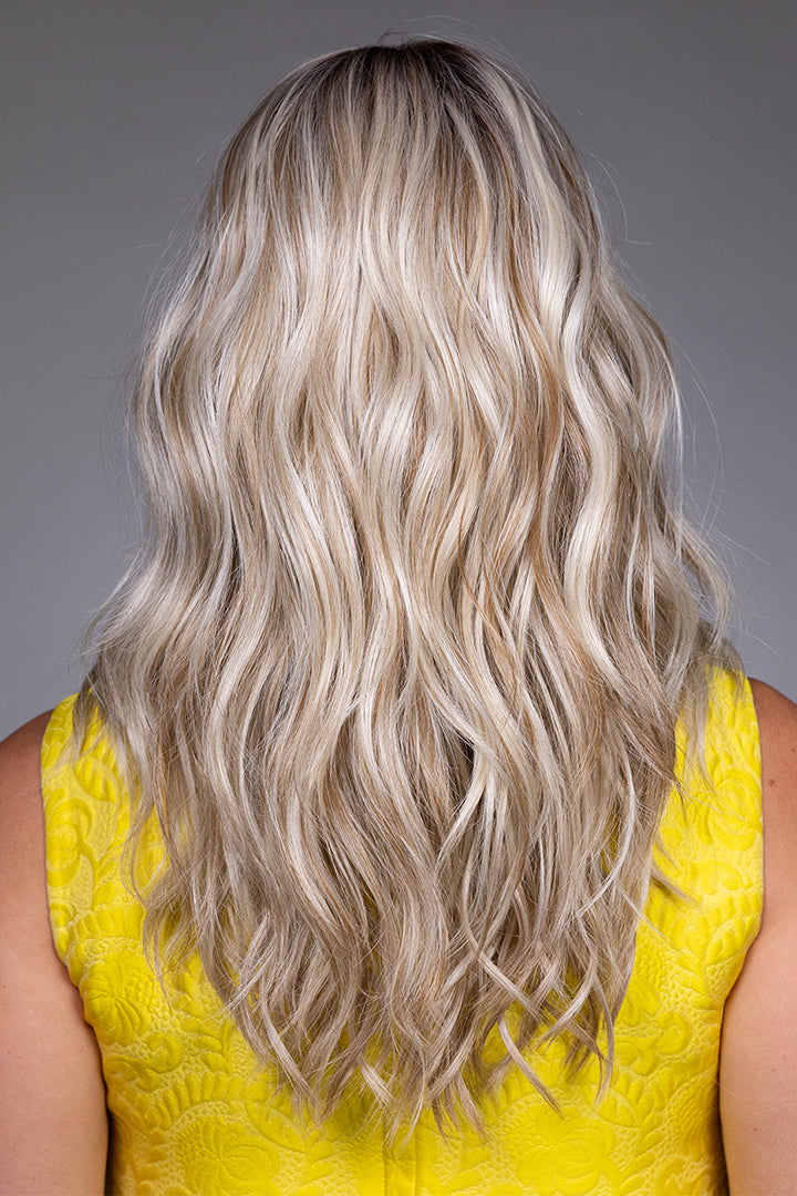 Back view of Bella by Belle Tress, a long blonde wavy synthetic wig with layered, voluminous heat-friendly fibers.