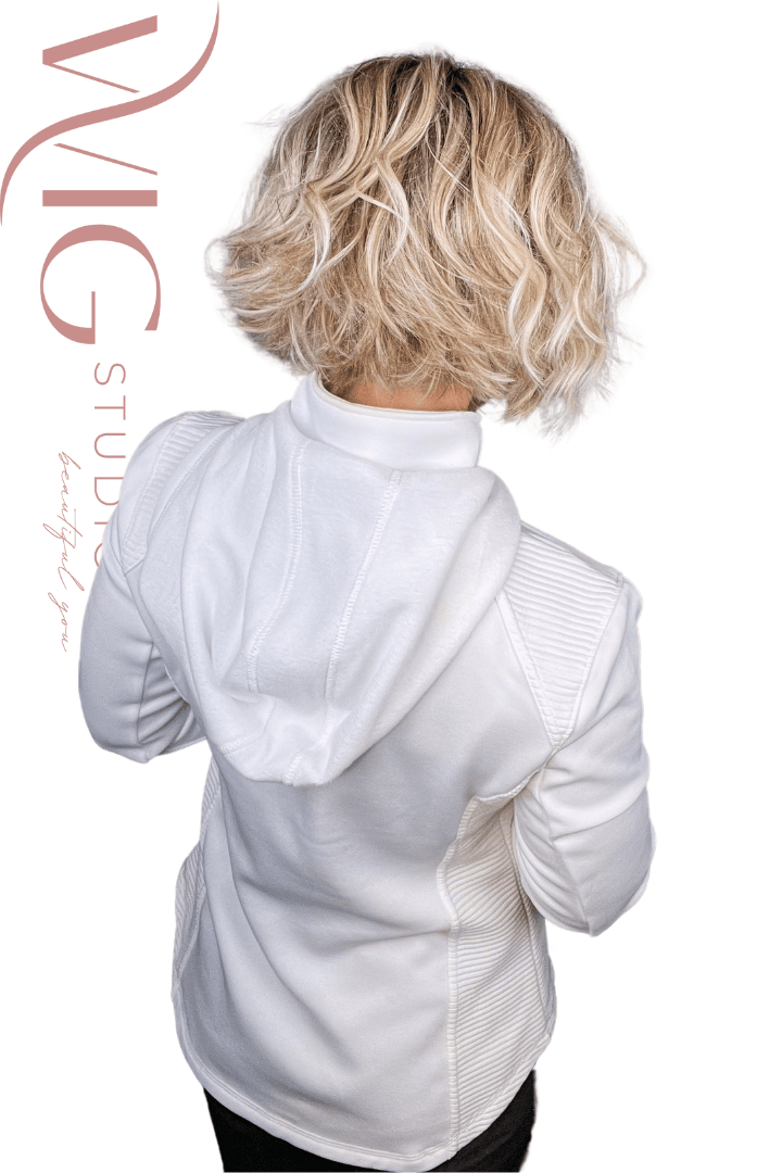 Woman wearing chin-length rooted blonde bob (Austen by Belle Tress in Milkshake Blonde R) back