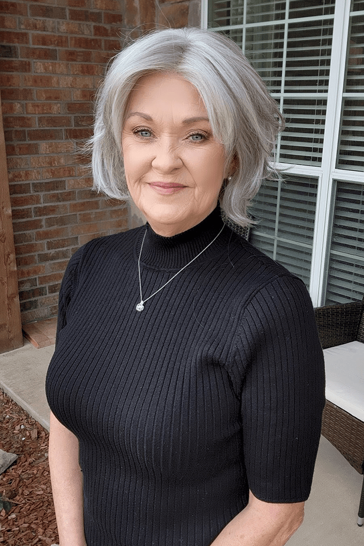 Woman with gray chin-length bob wig (Marni by Belle Tress in Iced Oyster)