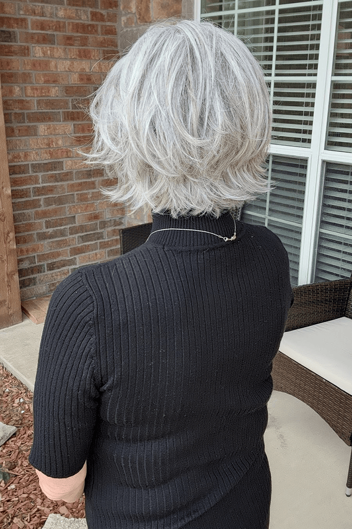 Woman with gray chin-length bob wig (Marni by Belle Tress in Iced Oyster) back