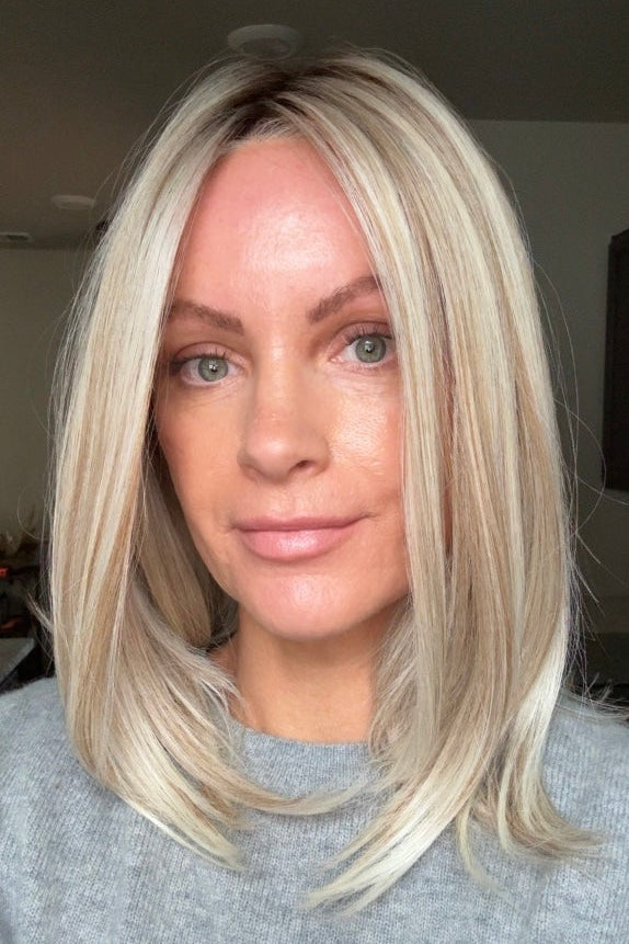 A woman with shoulder-length blonde wig (Adriana by Belle Tress in color Butterbeer Blonde)