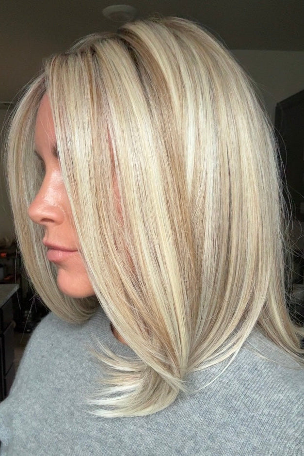 A woman with shoulder-length blonde wig (Adriana by Belle Tress in color Butterbeer Blonde)