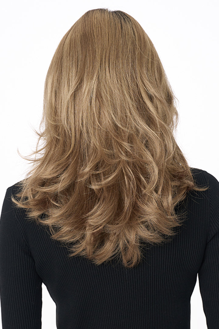 Bobbi by Envy long layered synthetic wig in a warm blonde shade, viewed from the back.