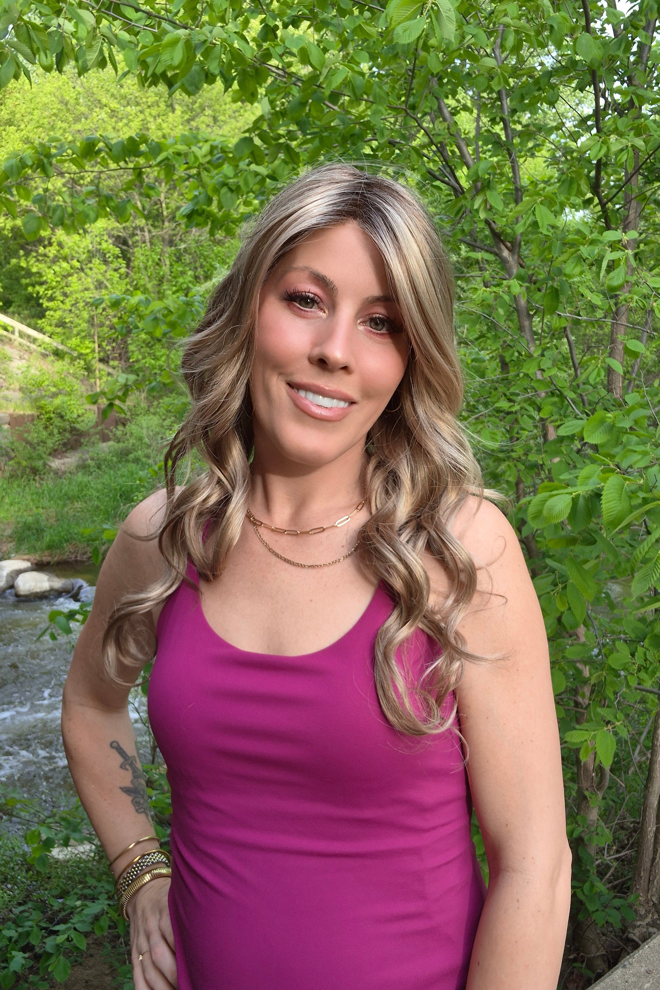 Woman wearing long layered wig with beachy waves (Brianna Hand-Tied in Prosecco).