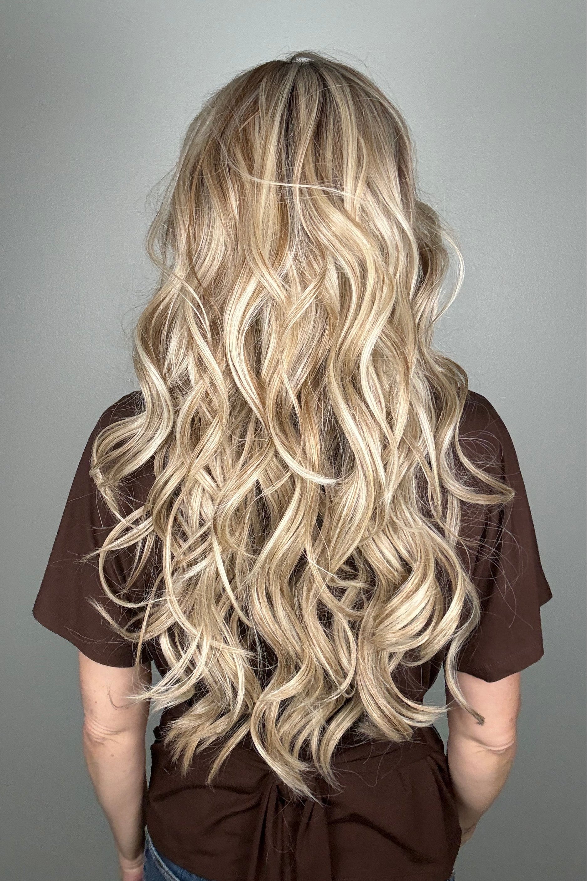 Woman wearing long curly rooted blonde wig (Carolina by Belle Tress in Rootbeer R).