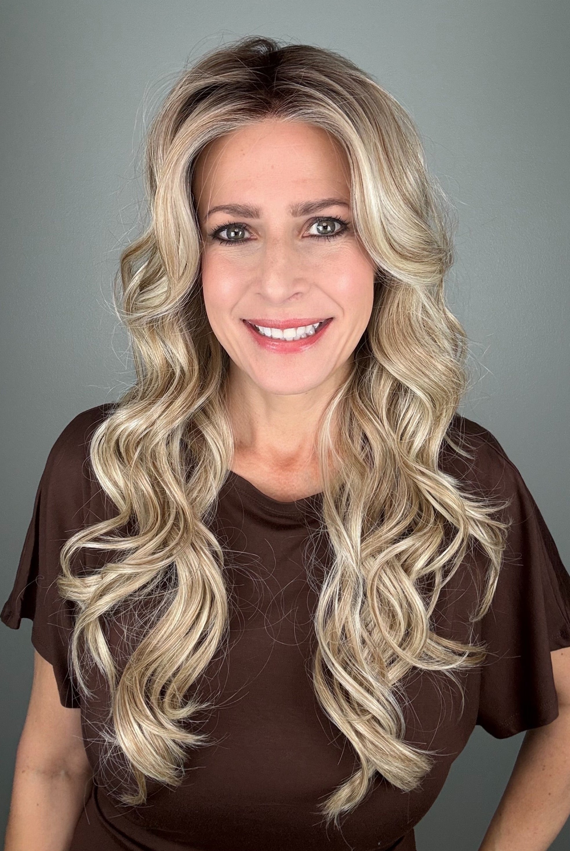 Woman wearing long curly rooted blonde wig (Carolina by Belle Tress in Rootbeer R).