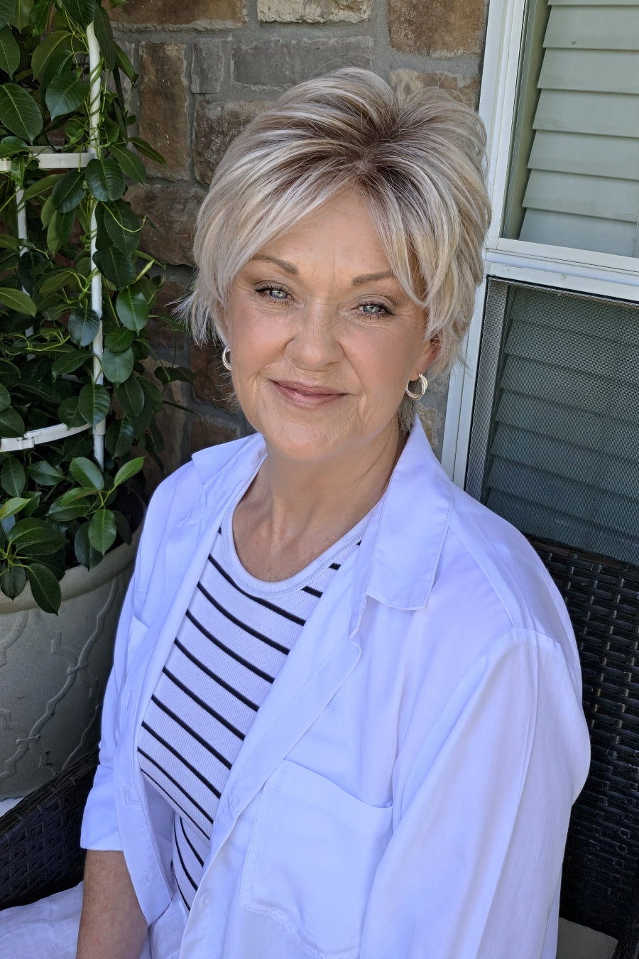 Woman wearing short layered pixie wig (Avenue Soft by Ellen Wille in Silver Blonde R)