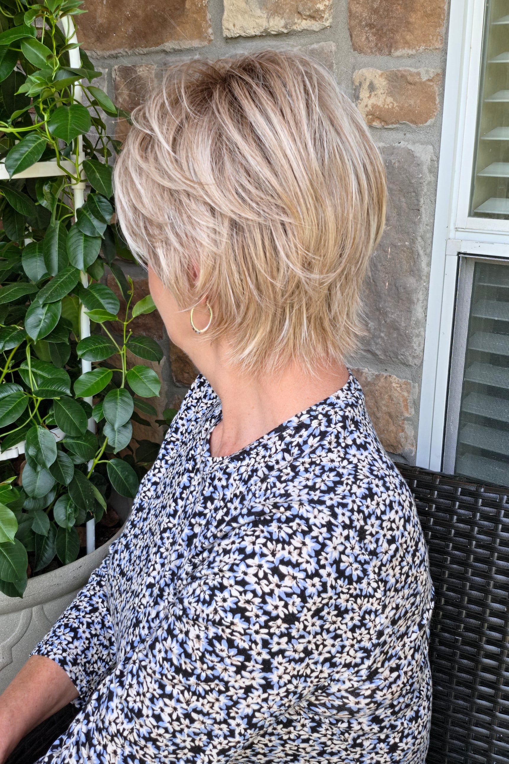 Woman wearing short layered pixie wig (Avenue Soft by Ellen Wille in Pearl Blonde R)