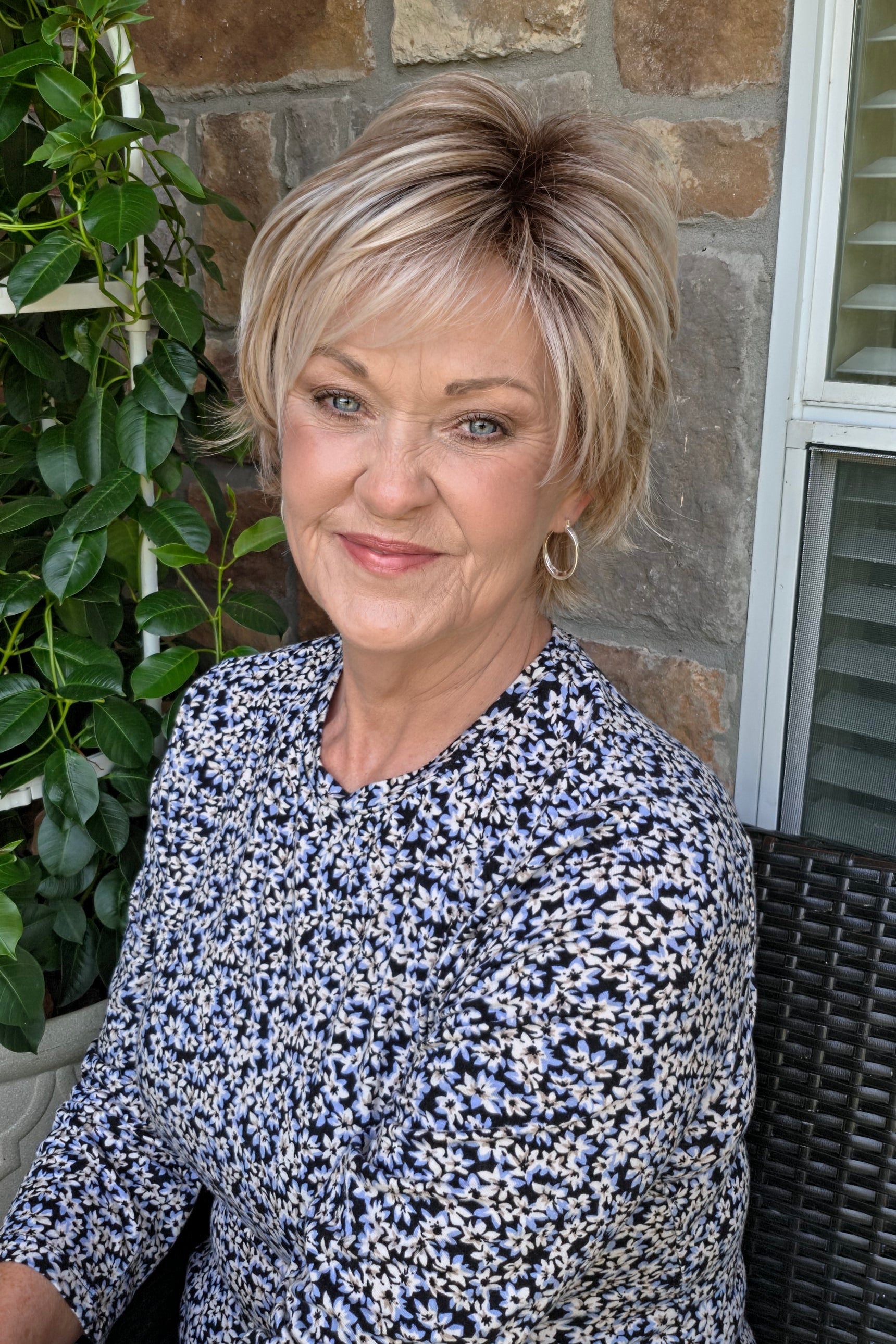 Woman wearing short layered pixie wig (Avenue Soft by Ellen Wille in Pearl Blonde R)