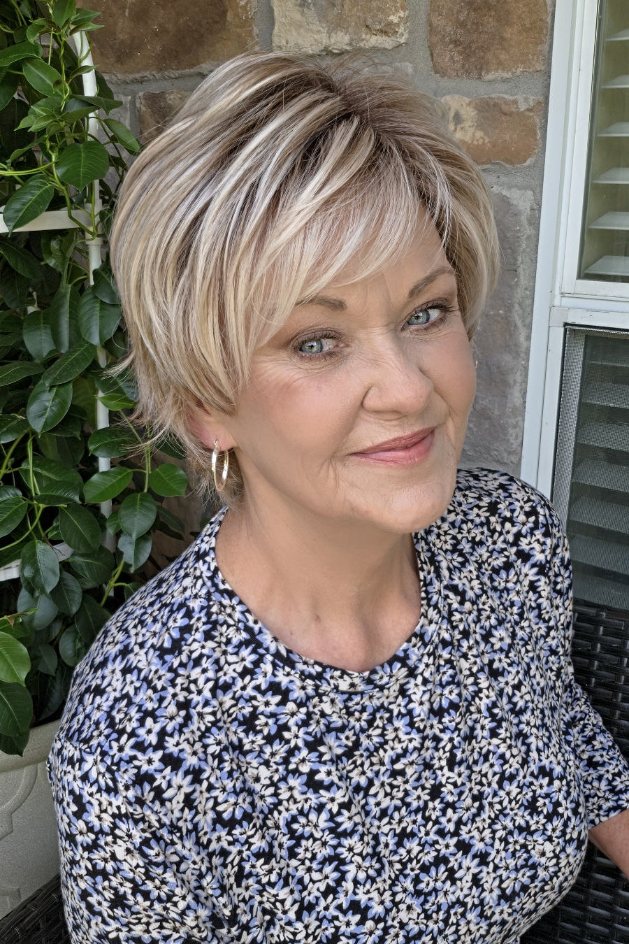 Woman wearing short layered pixie wig (Avenue Soft by Ellen Wille in Pearl Blonde R)