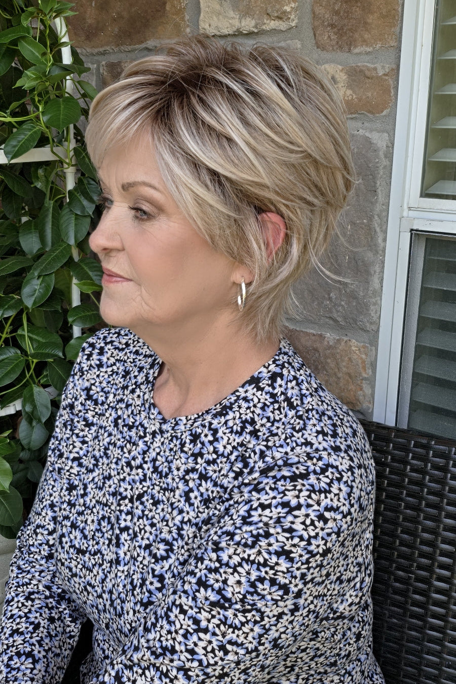 Woman wearing short layered pixie wig (Avenue Soft by Ellen Wille in Pearl Blonde R)