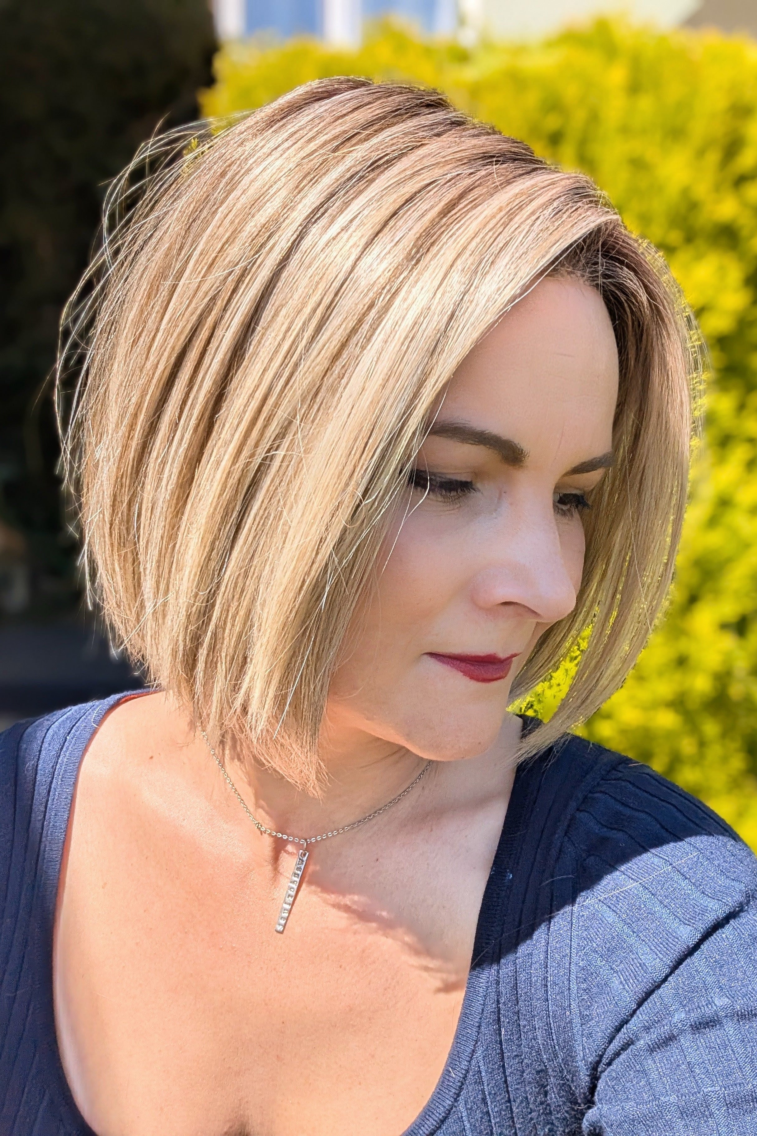 Woman wearing chin-length blonde bob wig (Euro Chic by TressAllure in Cashmere Cream)