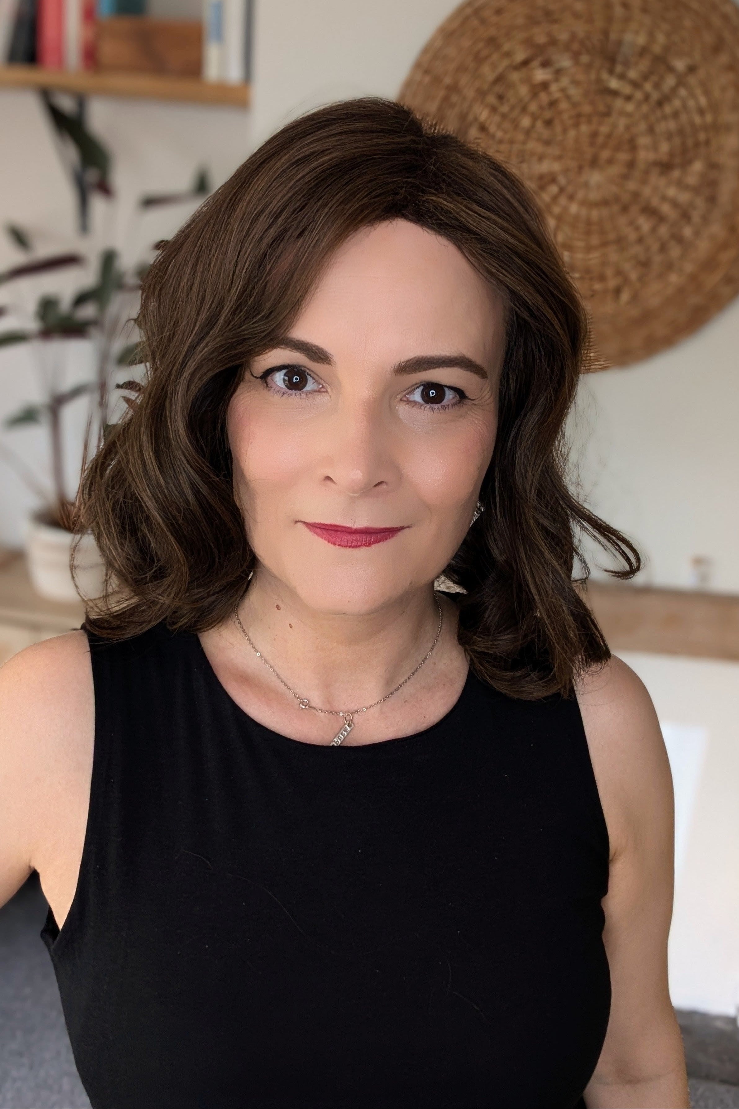 Woman wearing curled bob wig (Exhilaration by Gabor in Light Brown)