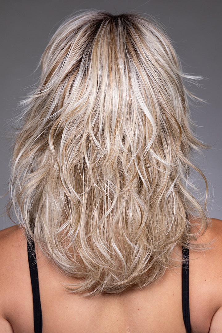 Back view of Farrah by Belle Tress, a blonde highlighted synthetic shag wig with choppy, textured layers.