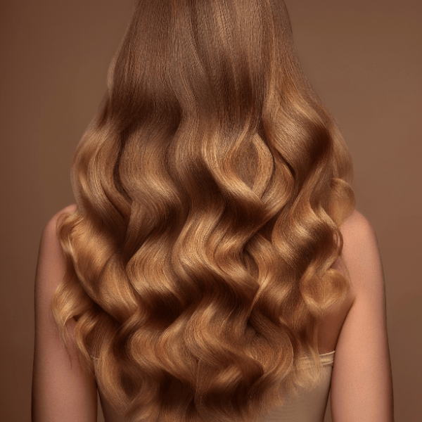 Close-up of wavy, brown hair on a brown background