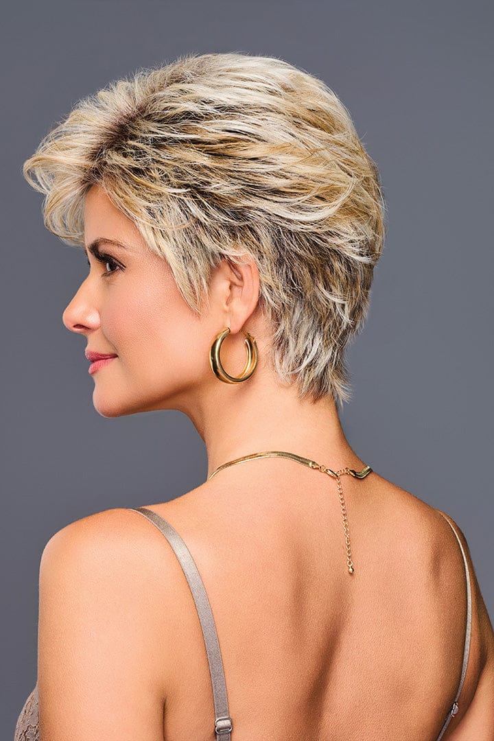 Woman with short blonde wig and gold jewelry