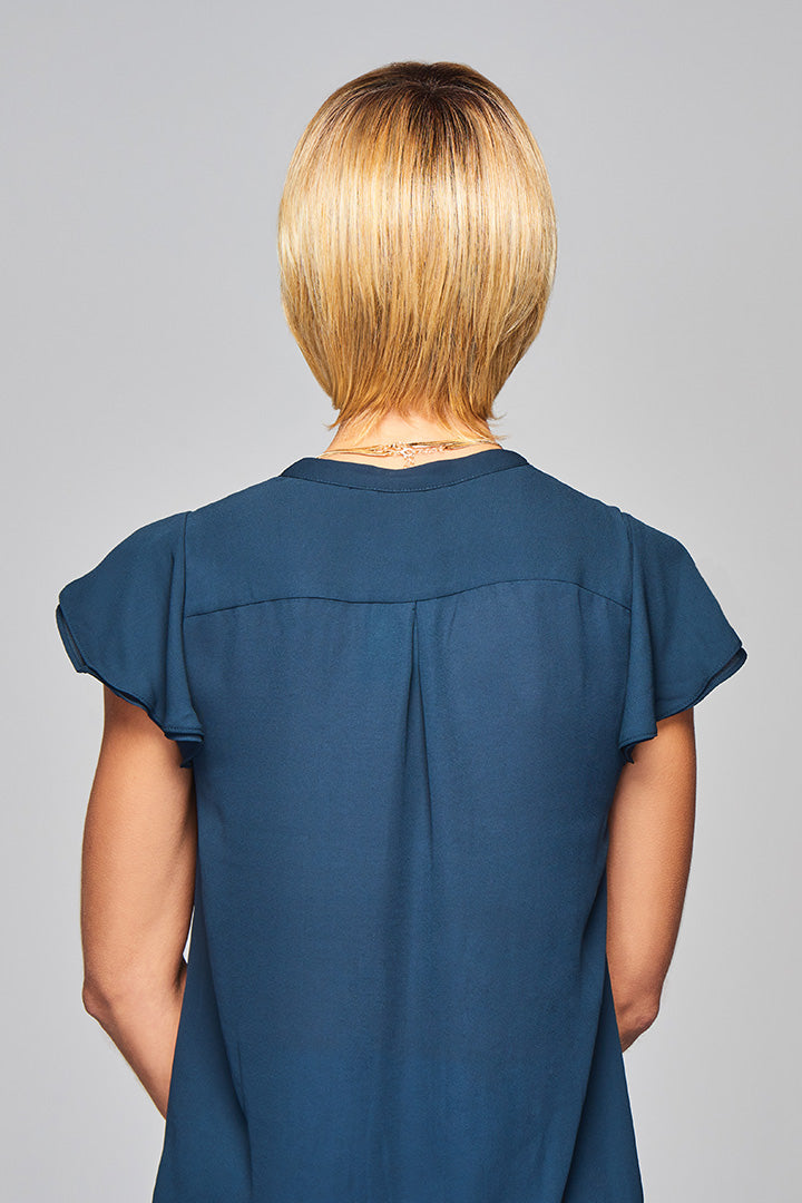Woman is wearing Enlighten wig by Gabor in SS Medium Blonde | Back