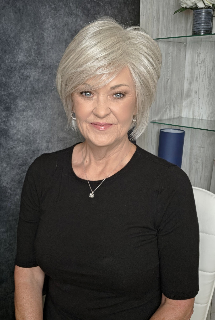Woman with chin-length blonde bob wig (Wonderful Wit by Gabor in Light Gray).