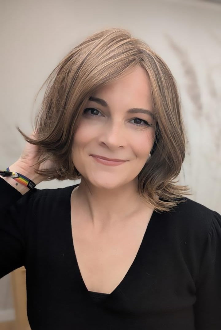Woman with short, styled brunette wig (Harper by WigPro in Camel Brown)