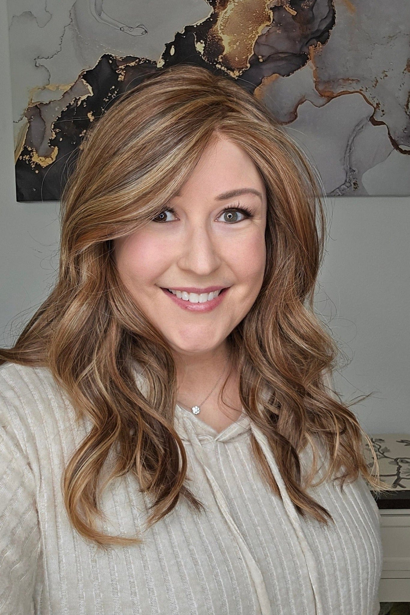 Woman wearing Nashville Synthetic wig by Henry Margu in color 8/27/33H