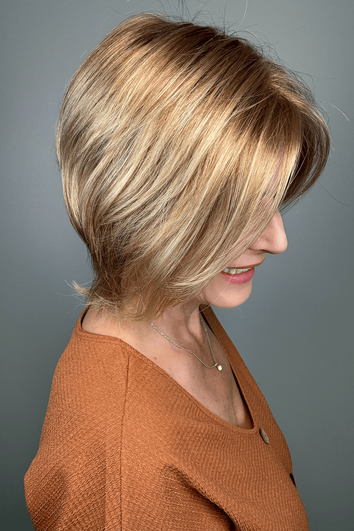 Woman wearing short angled bob cut blonde wig (Jon Renau's Idalia in 12FS8) side