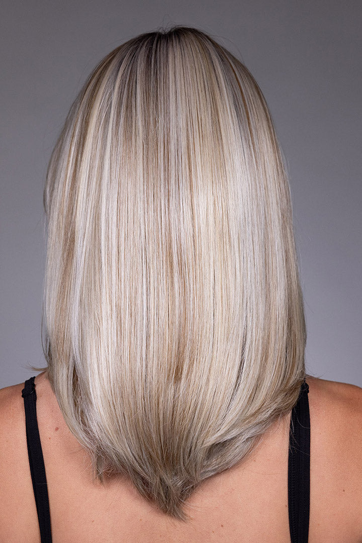 Back view of Jasmine by Belle Tress, a shoulder-length, layered blonde synthetic wig with a sleek, straight style.