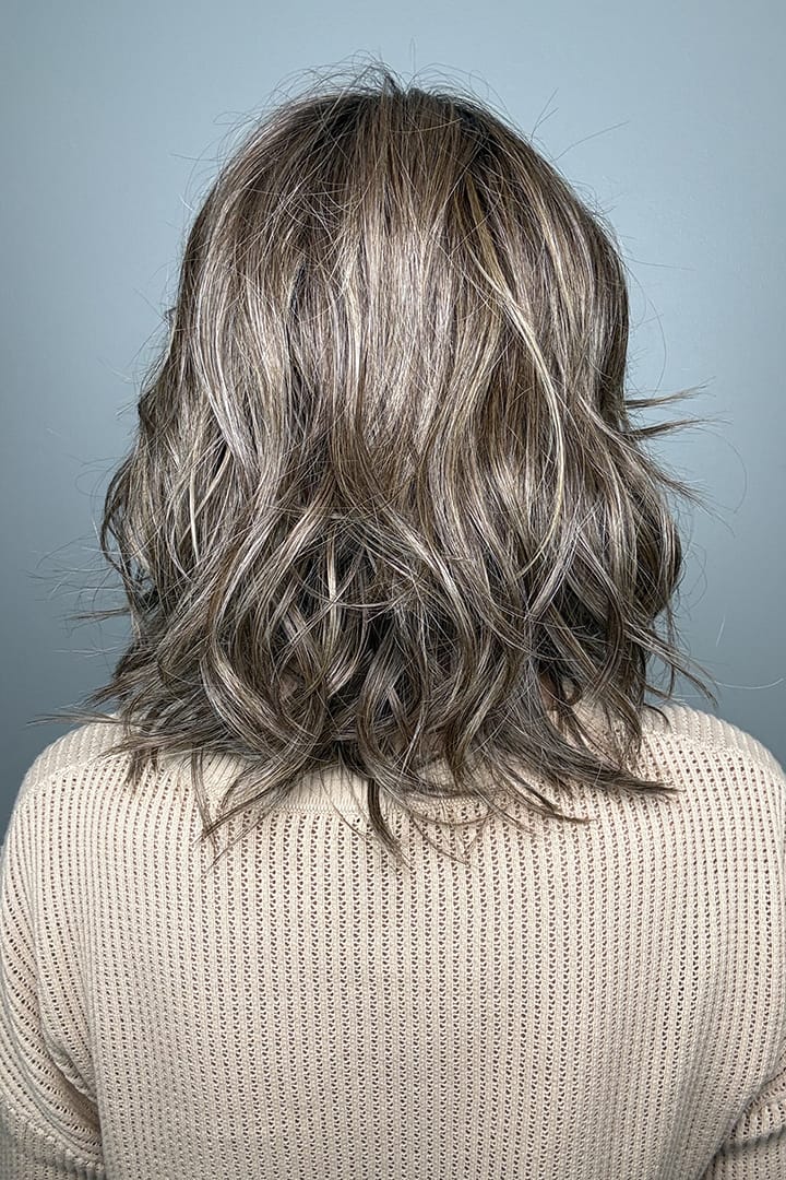 Woman wearing brunette wig with ash blonde highlights (Loryn by Rene of Paris in Caffe Misto R) ack
