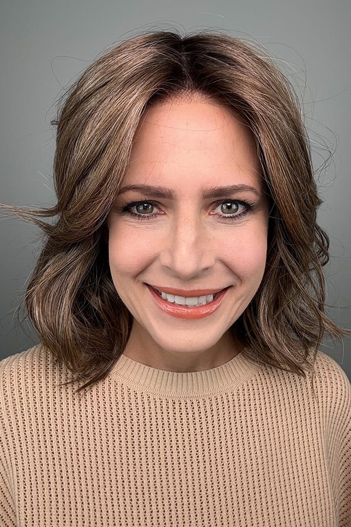 Woman wearing brunette wig with ash blonde highlights (Loryn by Rene of Paris in Caffe Misto R)