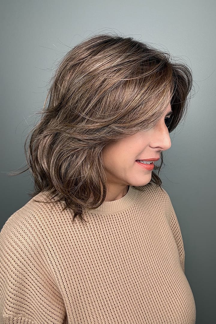 Woman wearing brunette wig with ash blonde highlights (Loryn by Rene of Paris in Caffe Misto R) side