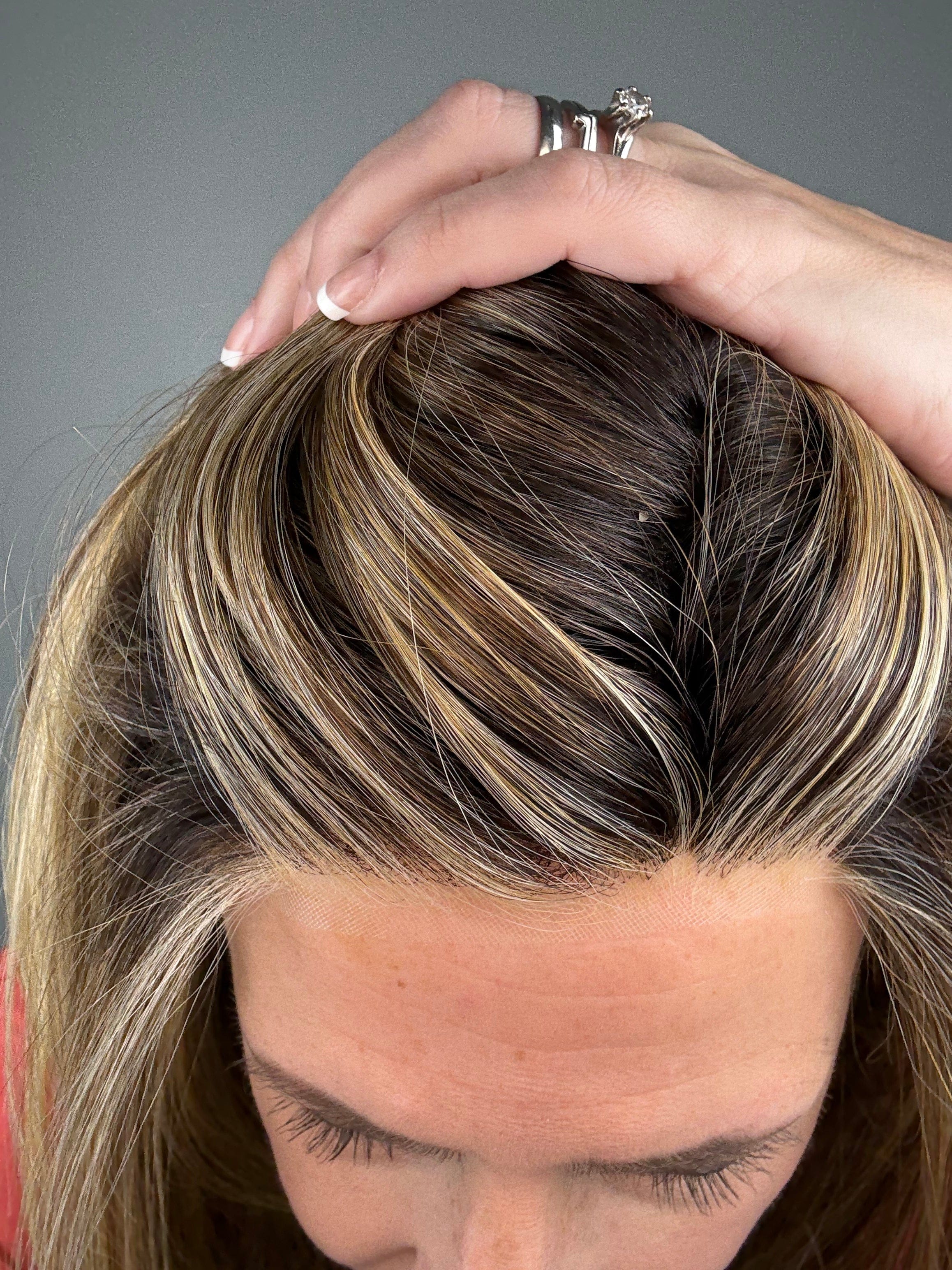 Woman wearing long layered wig (Mirror Moment by Gabor in Honey Pecan) hairline