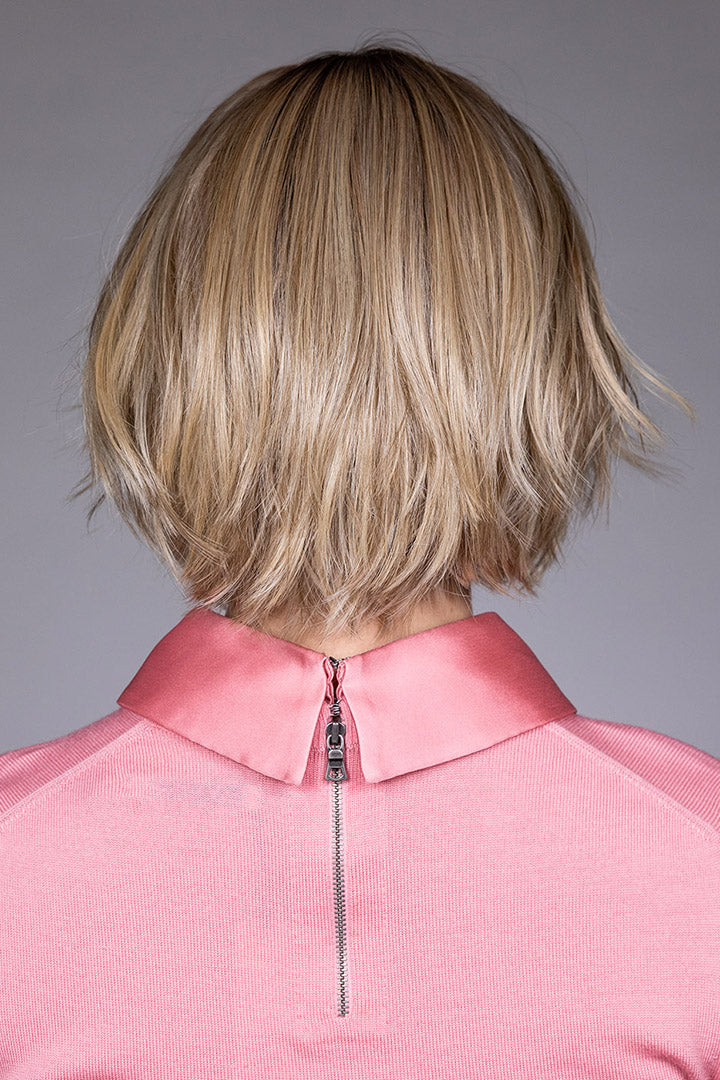 Woman wearing Oslo by Belle Tress in Raw Sugar Blonde R | Back, in pink shirt