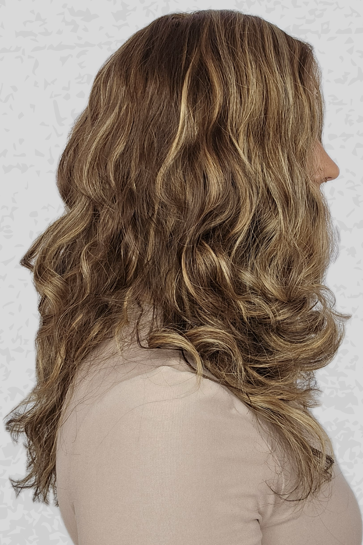 Side profile of woman with long, wavy hair wearing a 16-24 inch Bespoke wig from PUSH Hair in color Belle