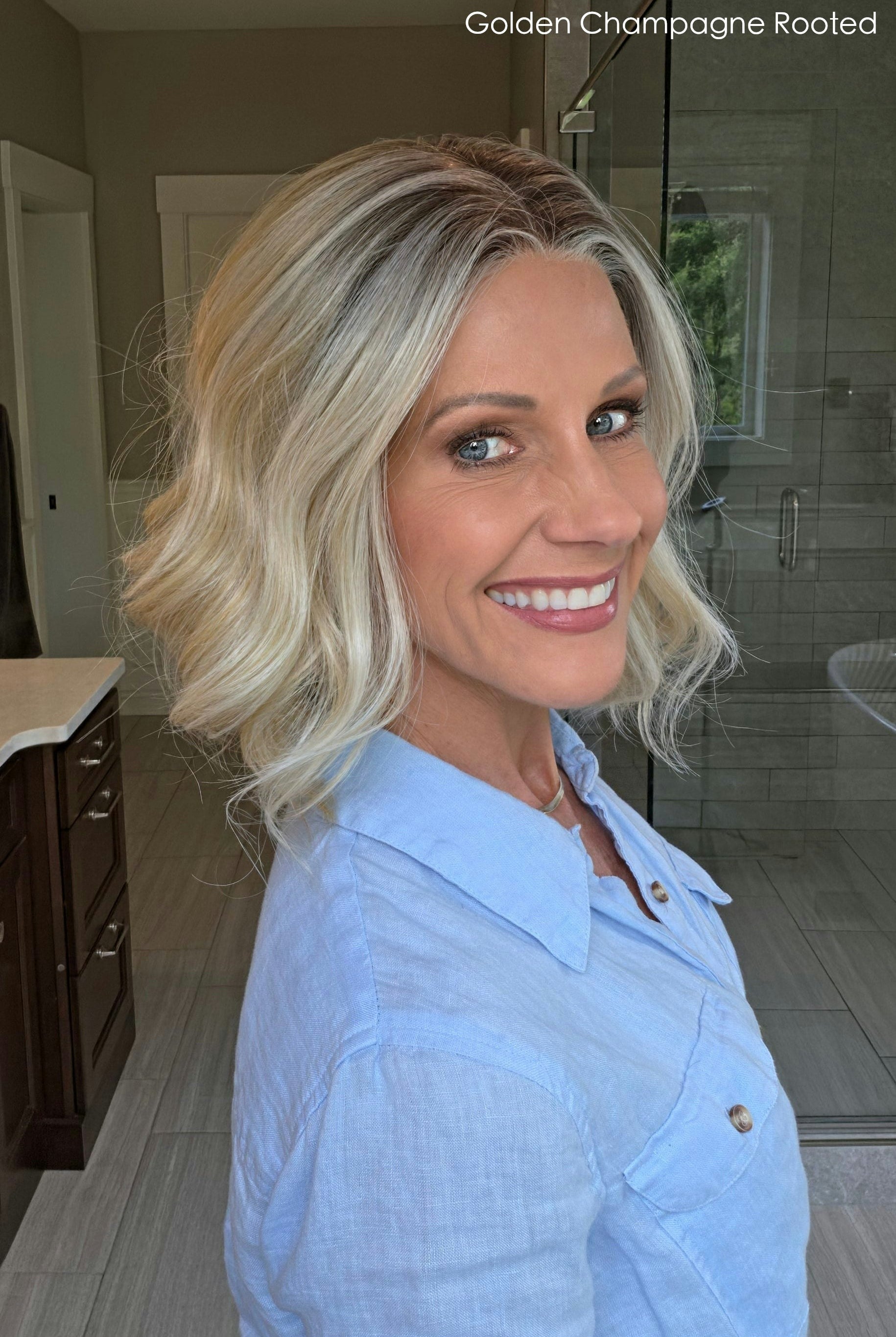 Woman wearing shoulder length curly blonde wig (Brielle by PUSH Hair in color Golden Champagne R)