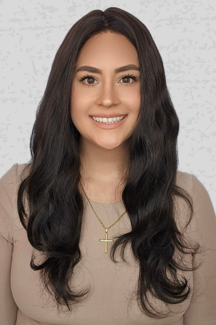 Woman with long black hair wearing PUSH Hair's Bespoke 24" in color 1B on a light gray background