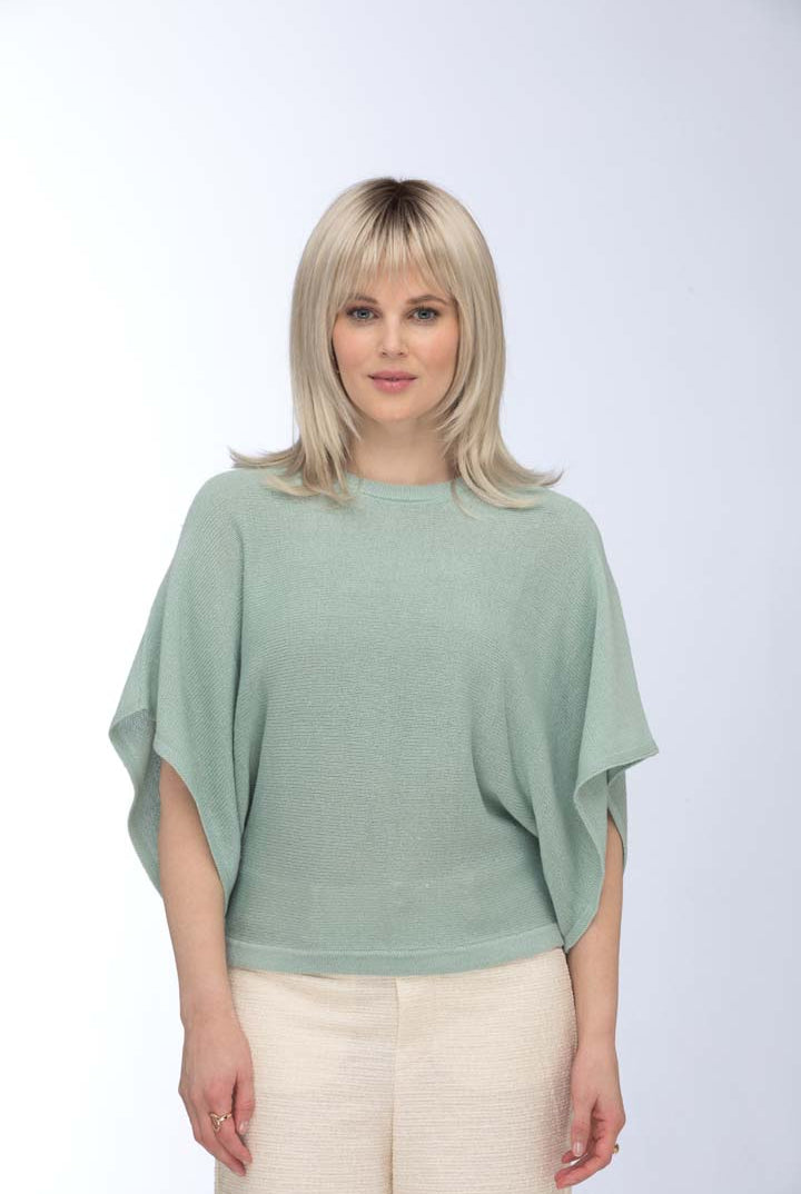 Roma by Estetica synthetic mid-length blonde wig with soft layers, feathered ends, and a natural lace front.