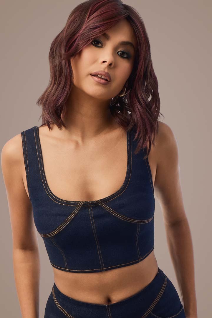 Woman with smooth, plum-brown wavy hair & denim top