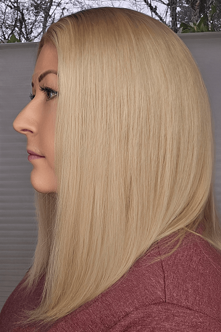Woman with long blonde hair in a side profile view