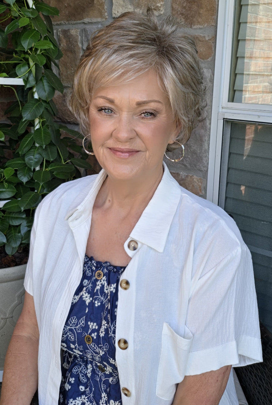 A woman with short textured blonde wig (Kenzie by Tony of Beverly in Silverstone).