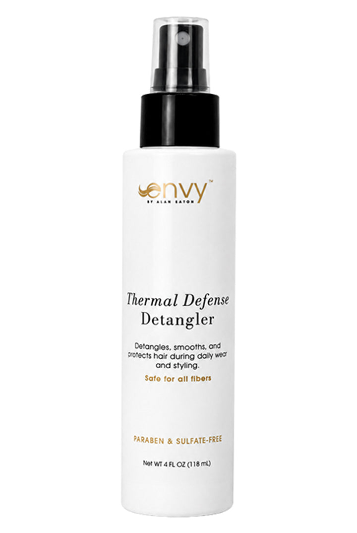 White 4 fl oz spray bottle of Envy Thermal Defense Detangler with a black pump cap and clear lid on a white background.