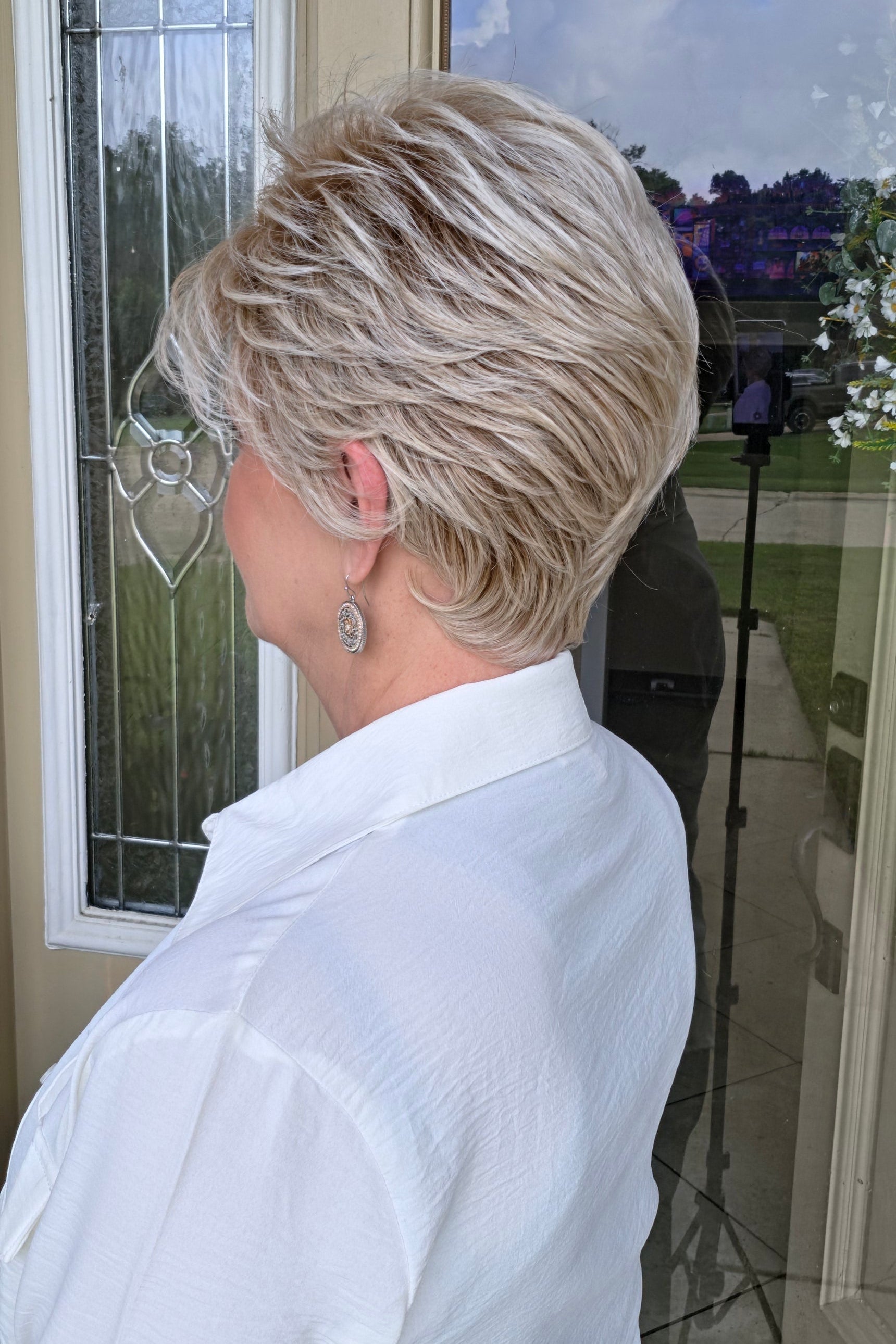 Woman with short blonde pixie wig (Angelic by Toni Brattin in Platinum)
