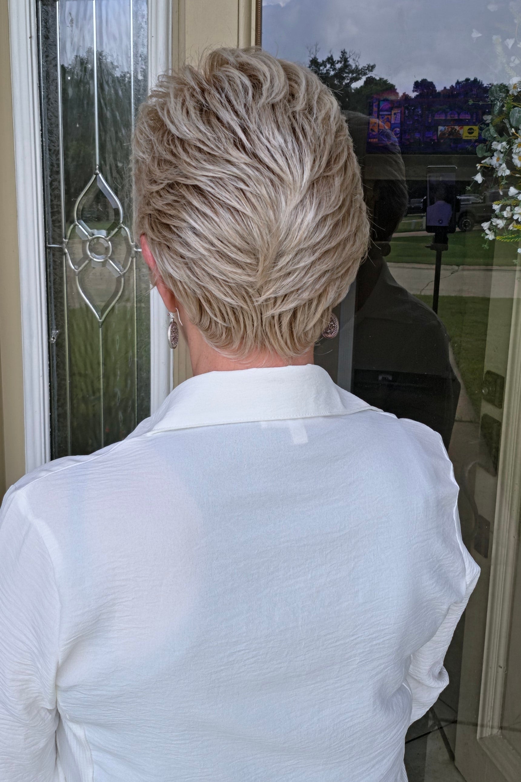 Woman with short blonde pixie wig (Angelic by Toni Brattin in Platinum)