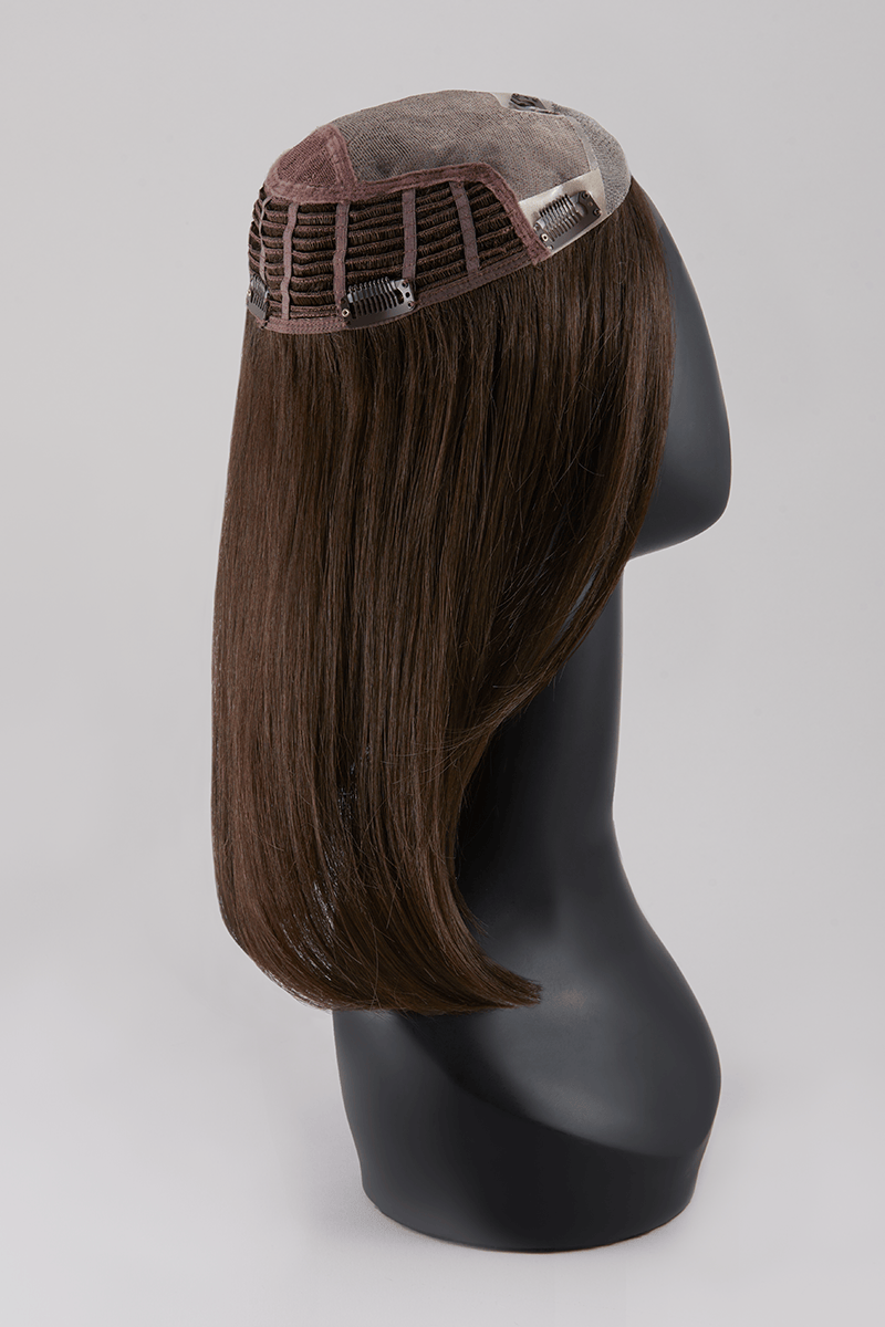 Synthetic hair topper on mannequin head