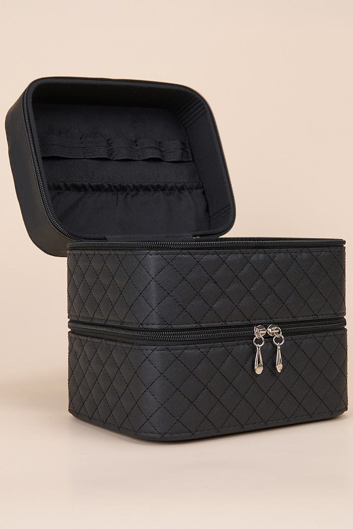 Black quilted travel case, open showing interior storage.