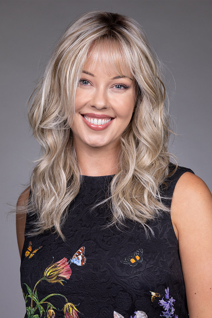Vesper by Belle Tress synthetic shag wig with wispy bangs, layered blonde waves, and a natural lace front.