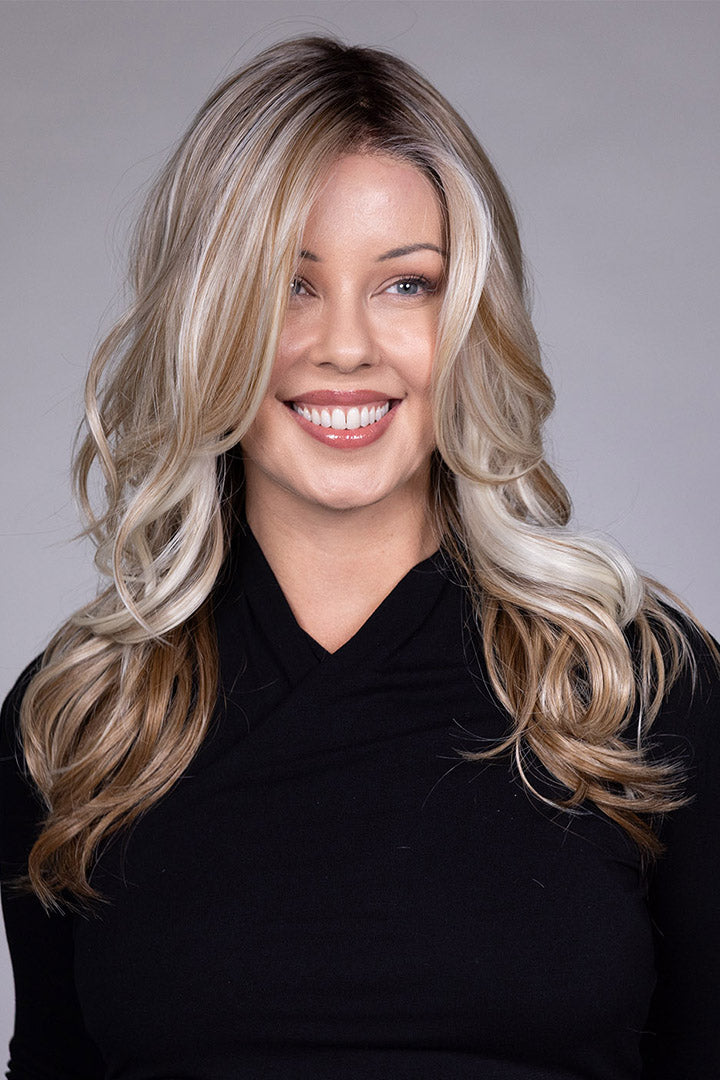 Wisteria by Belle Tress long wavy synthetic wig with blonde money piece highlights and a lace front.