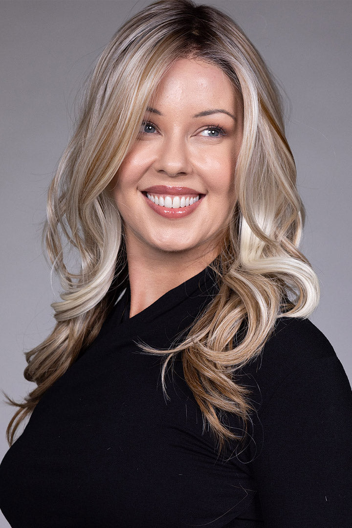 Wisteria by Belle Tress long wavy synthetic wig with face-framing blonde money piece highlights and lace front.